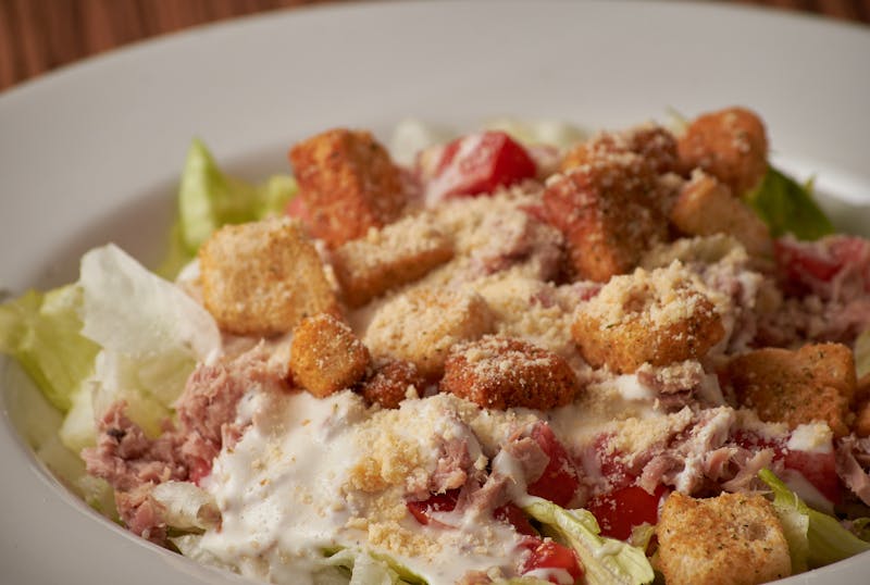 Classic Caesar salad with croutons and Parmesan shavings